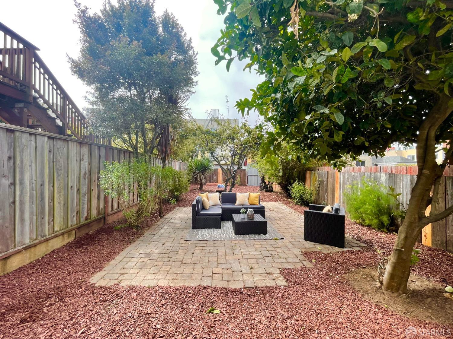 37 Ruth Street San Francisco, CA 94112 - Photo 22 of 26 a view of a patio with couches and a table and chairs with wooden fence and plants