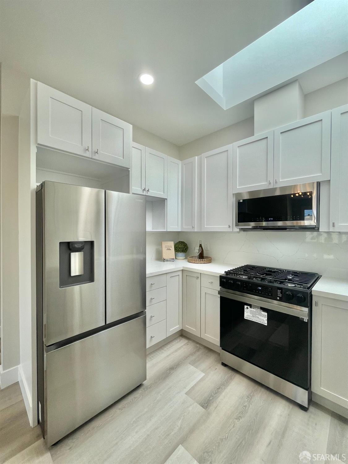 37 Ruth Street San Francisco, CA 94112 - Photo 8 of 26 a kitchen with a refrigerator stove and microwave