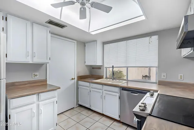a kitchen with a sink appliances and cabinets