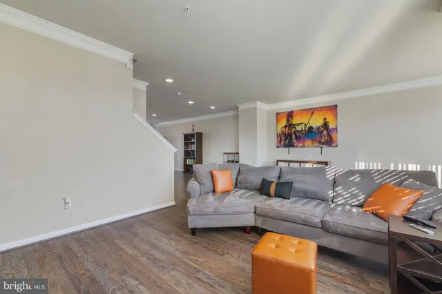 a view of a room with furniture and wooden floor