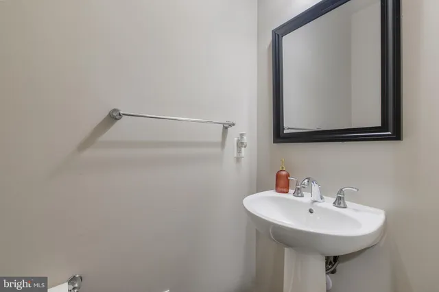 a living room with furniture and a book shelf