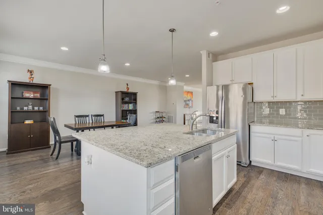 a spacious bedroom with a bed and dresser