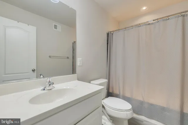 a bedroom with a large bed and a dresser