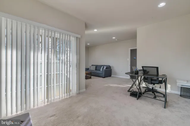 a living room with furniture a window and a flat screen tv