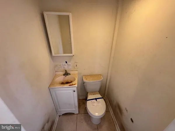 a white toilet sitting next to a bathroom sink