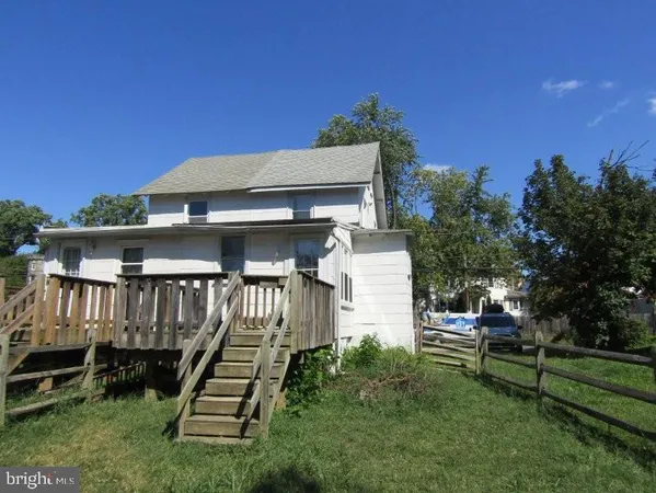 a view of backyard with a garden and deck