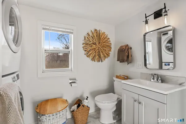 a bathroom with a toilet a sink and a mirror