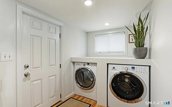 a view of a hallway with washer and dryer