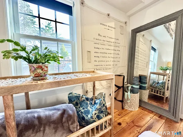 a living room with furniture and floor to ceiling windows