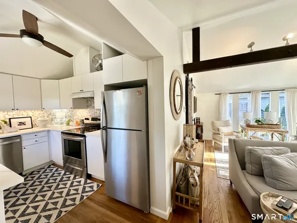 a kitchen with a refrigerator microwave and stove top oven