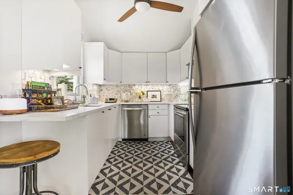 a kitchen with a refrigerator a sink and cabinets