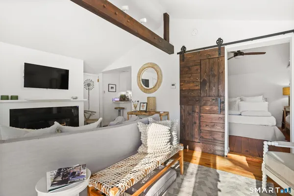 a living room with furniture a flat screen tv and a fireplace