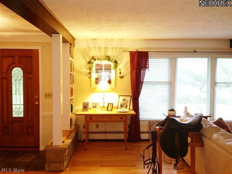 4991 Fenn Road Medina, OH 44256 - Photo 11 of 21 Here's a photo of the front entry with its beveled glass front door, wood flooring, more built-in shelving and large window display. Many windows in the home were replaced in the 1990's.