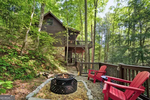 a roof deck with couches and wooden fence