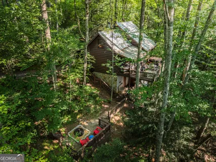 a view of a balcony with wooden floor and floor to ceiling window