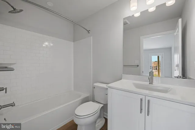 a bathroom with a sink toilet vanity and shower