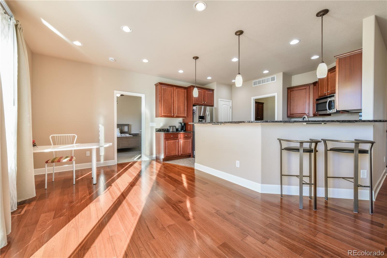 10484 Mile Post Loop Fountain, CO 80817 - Photo 11 of 50 a large kitchen with lots of counter space and a dining table