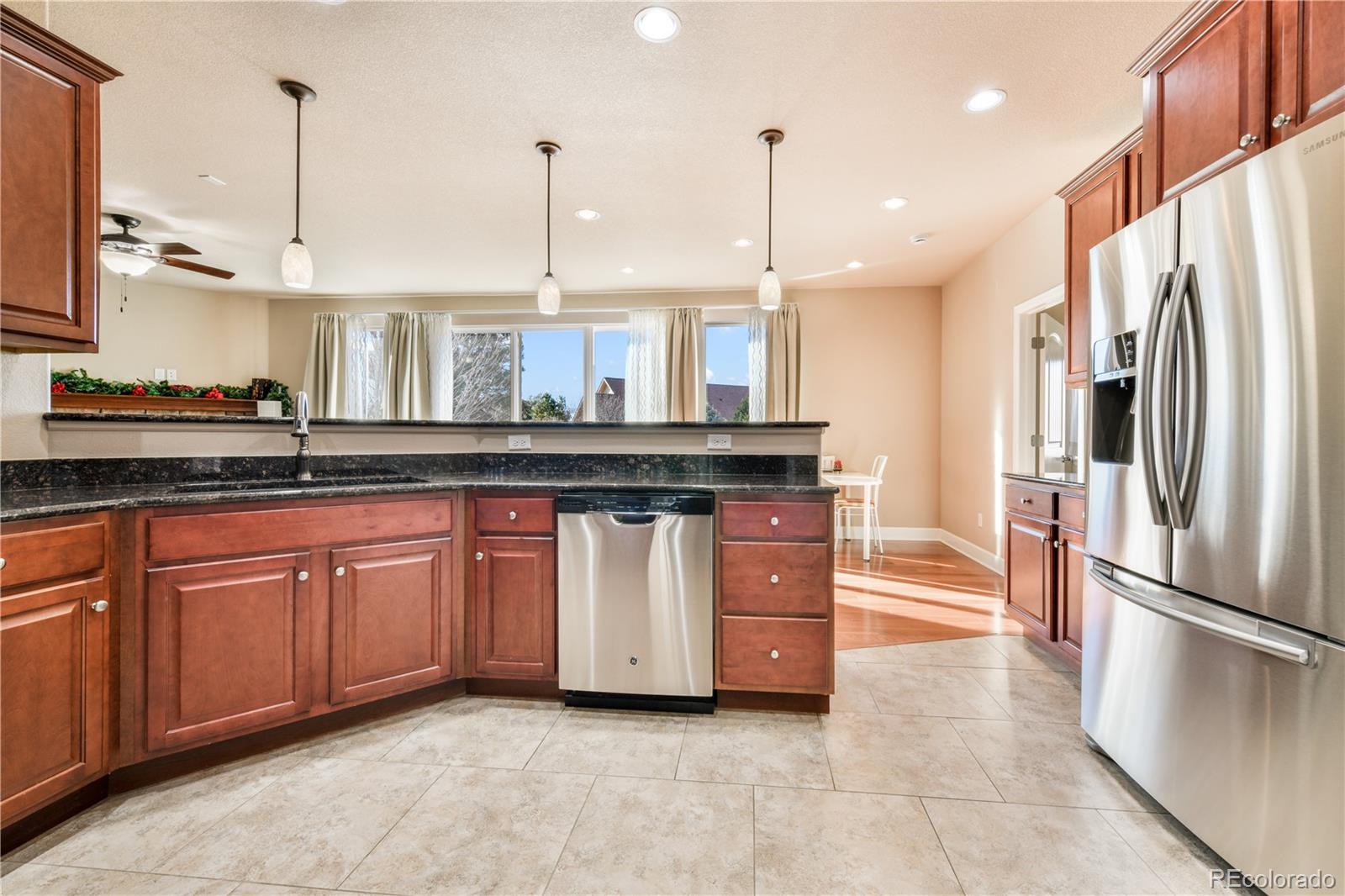 10484 Mile Post Loop Fountain, CO 80817 - Photo 15 of 50 a kitchen with stainless steel appliances granite countertop a sink a stove and a refrigerator