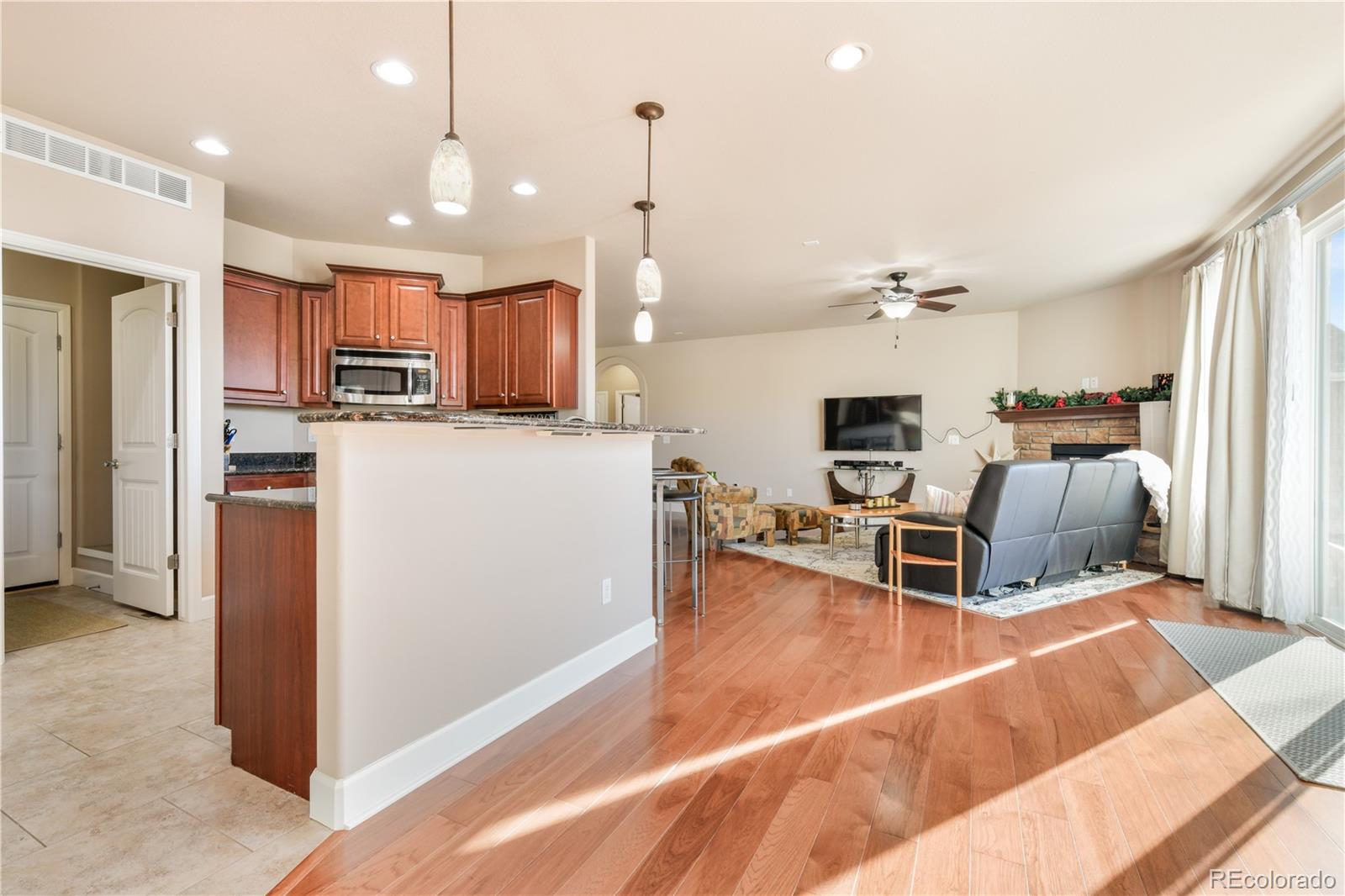 10484 Mile Post Loop Fountain, CO 80817 - Photo 16 of 50 a living room with stainless steel appliances kitchen island granite countertop furniture and a view of kitchen