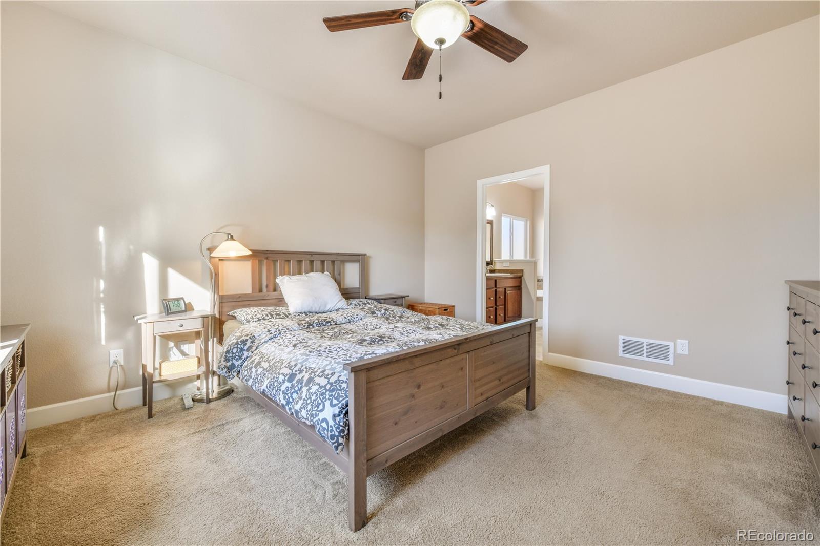 10484 Mile Post Loop Fountain, CO 80817 - Photo 17 of 50 a bedroom with a bed and a chandelier