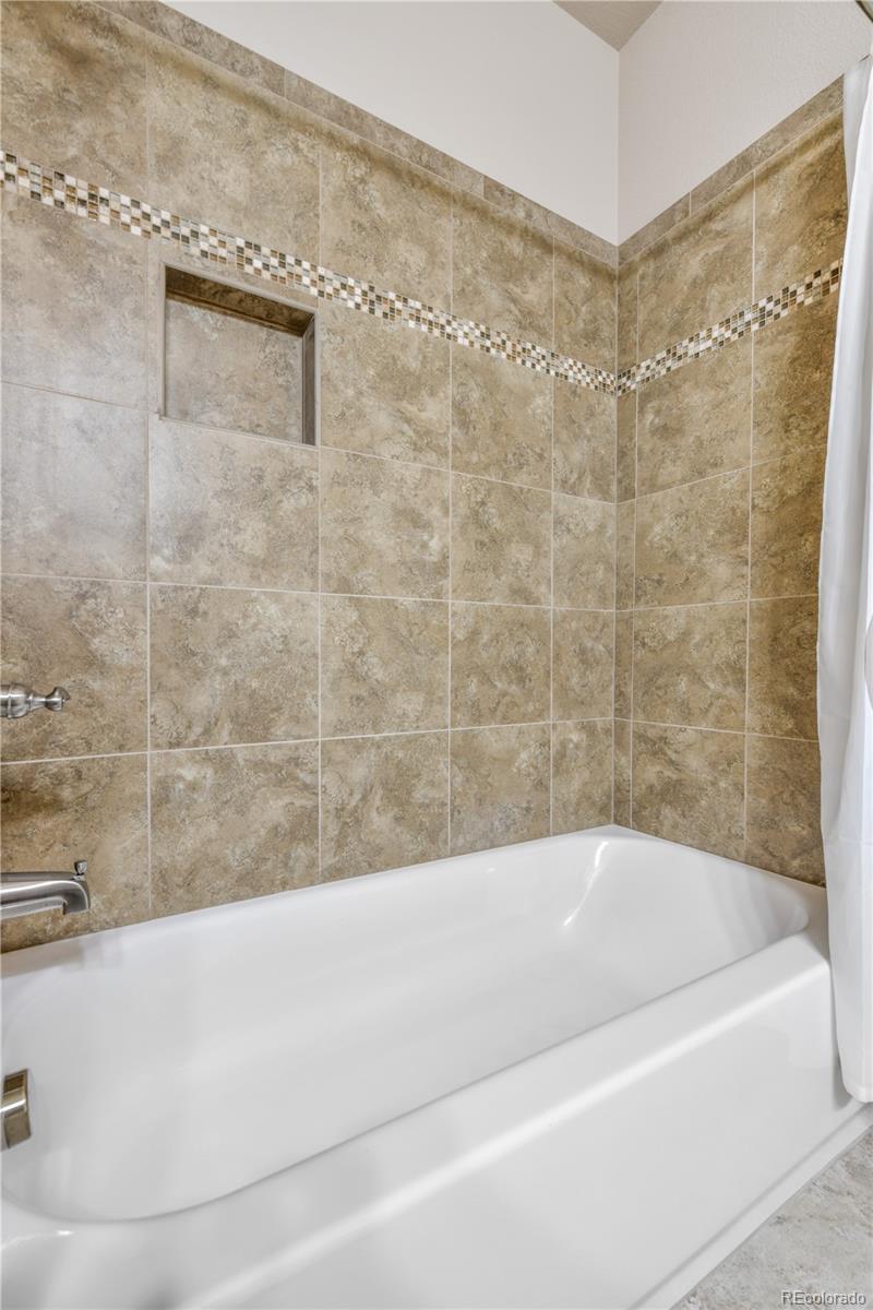 10484 Mile Post Loop Fountain, CO 80817 - Photo 30 of 50 a bathroom with a bathtub