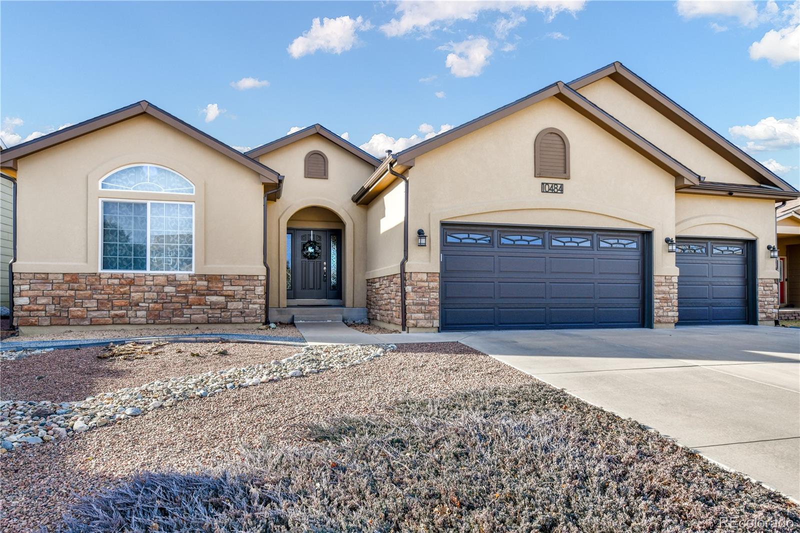 10484 Mile Post Loop Fountain, CO 80817 - Photo 42 of 50 a front view of a house with a yard and garage