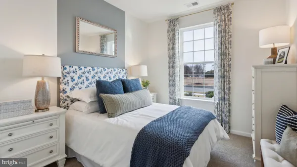 a bedroom with a bed and lamp