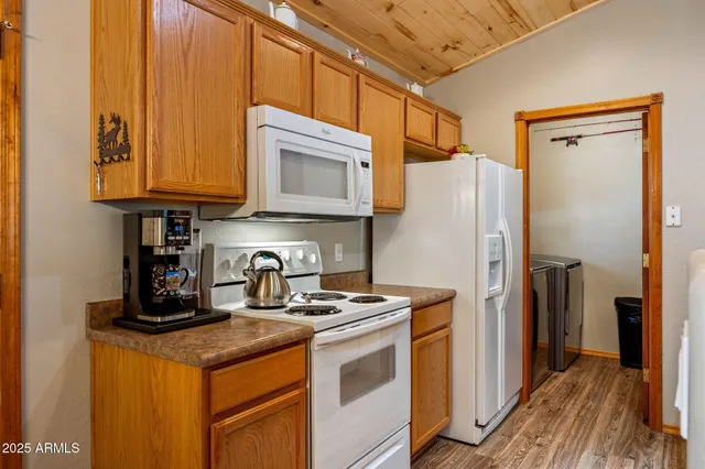 a dining room with furniture and a refrigerator