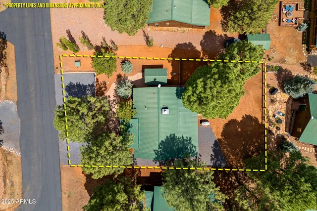 an aerial view of a house with a yard and garden