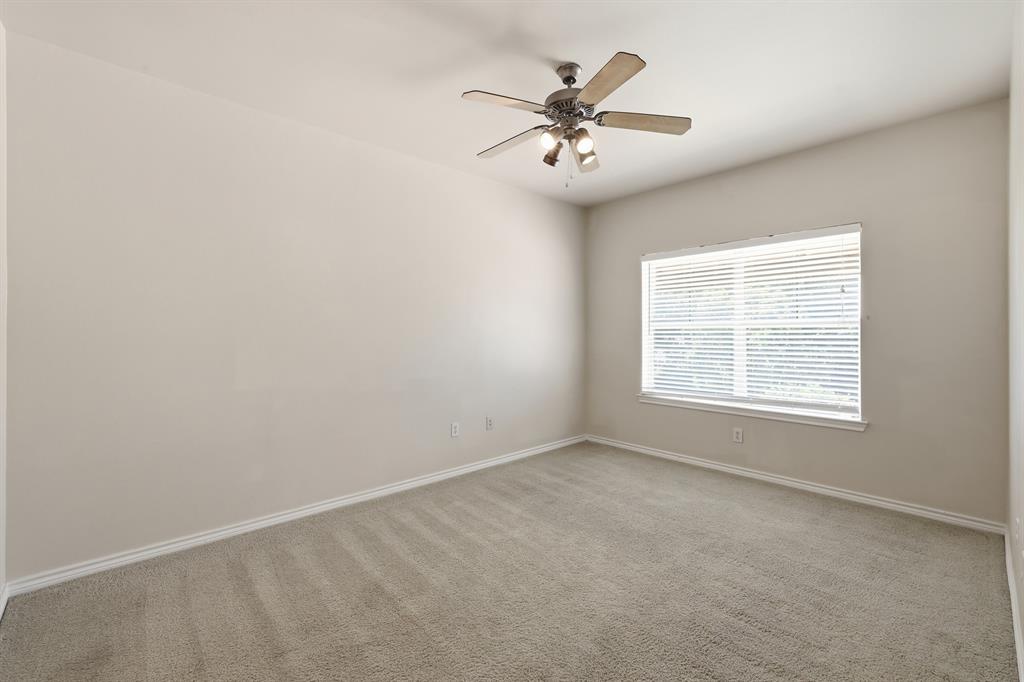 3102 Kings Road, Unit 2212 Dallas, TX 75219 - Photo 11 of 30 an empty room with chandelier fan and windows
