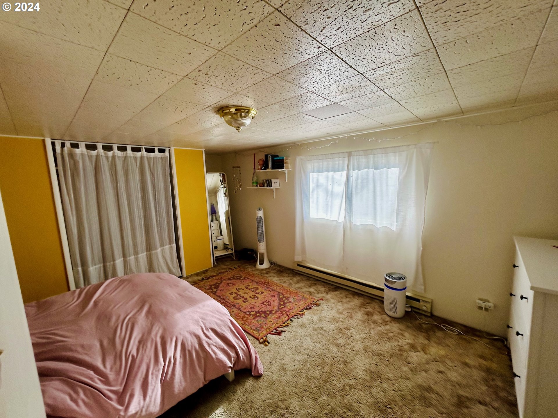 1539 Villard Street Eugene, OR 97403 - Photo 10 of 13 a bed sitting in a spacious bedroom next to a window
