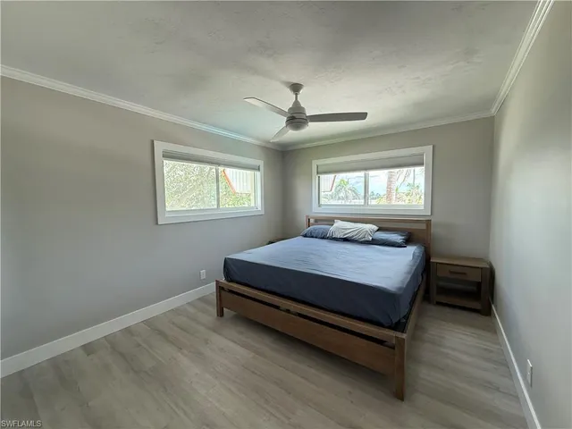 a bed sitting in a bedroom next to a window