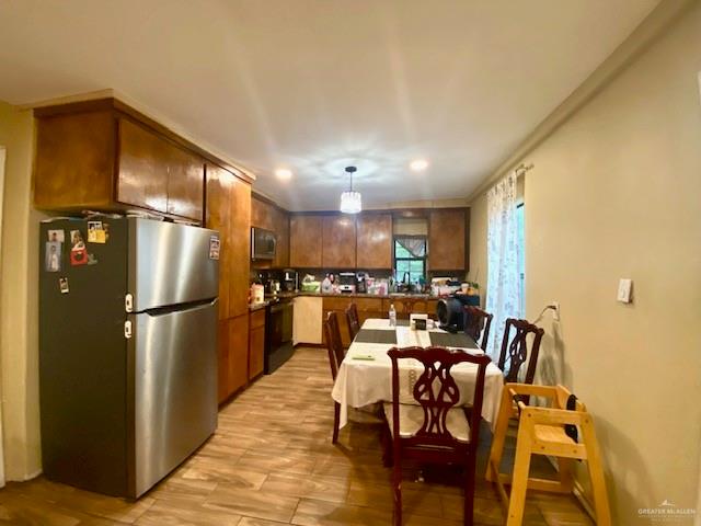 5910 Alpine Avenue Mission, TX 78574 - Photo 6 of 15 a kitchen with a refrigerator and a dining table