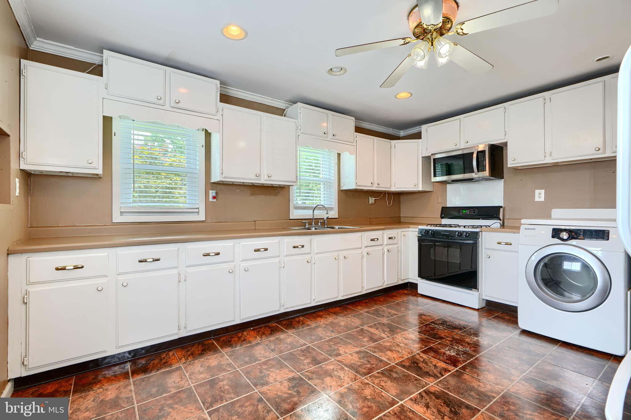 235 Trappe Road Baltimore, MD 21222 - Photo 15 of 37 a kitchen with a stove a sink and cabinets