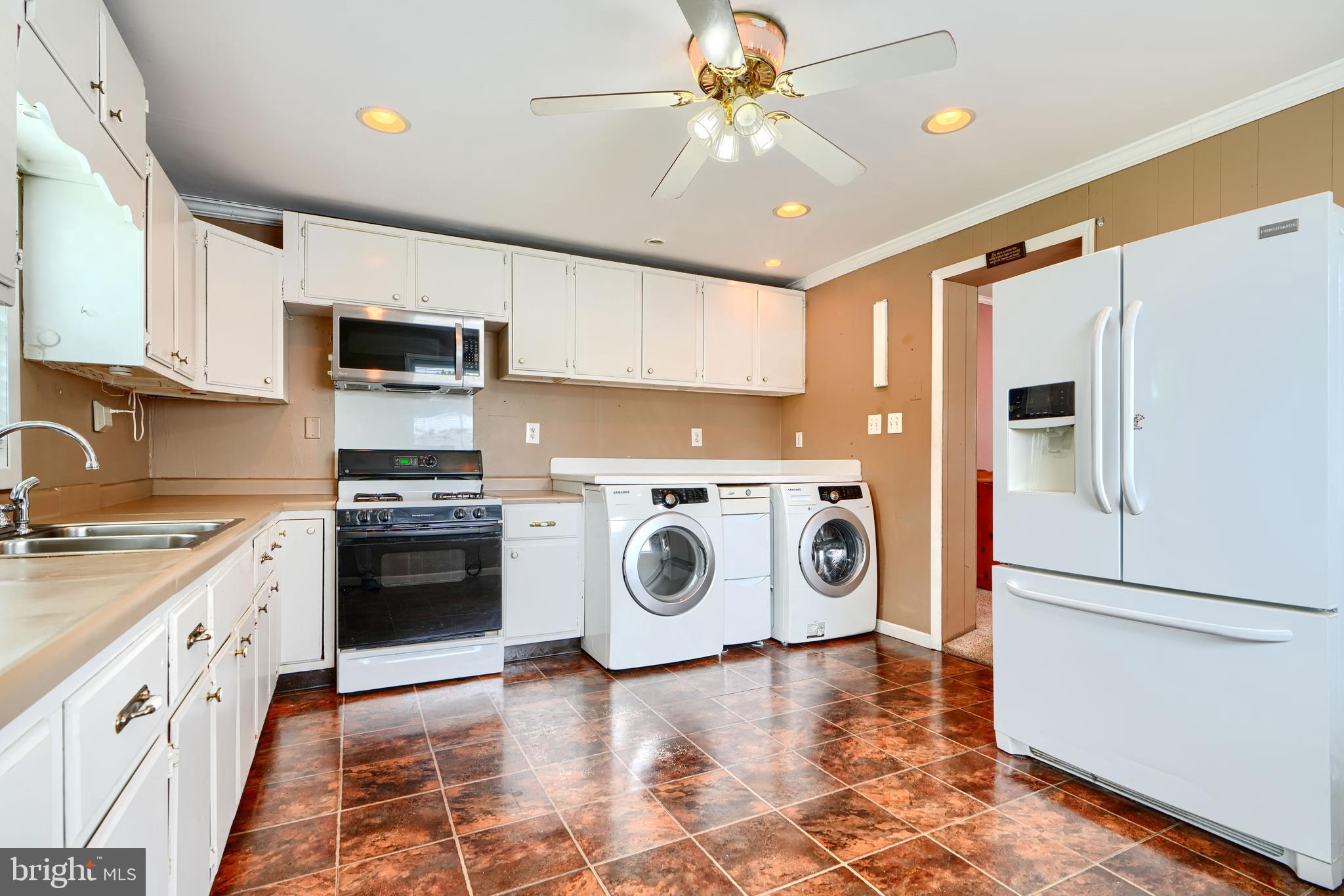 235 Trappe Road Baltimore, MD 21222 - Photo 16 of 37 a kitchen with stainless steel appliances granite countertop a refrigerator a stove a sink and a microwave