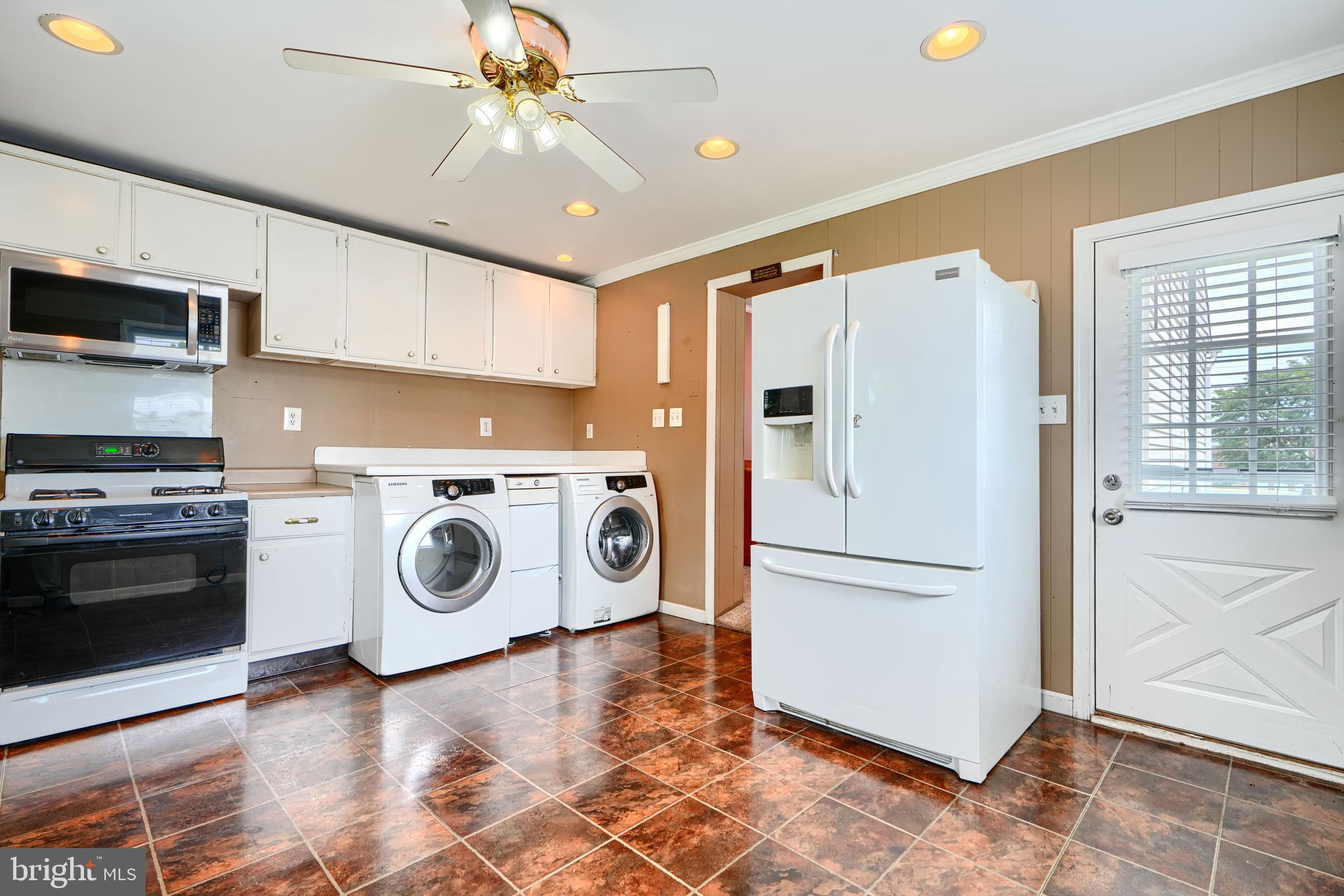 235 Trappe Road Baltimore, MD 21222 - Photo 17 of 37 a kitchen with a refrigerator a stove a washer and dryer