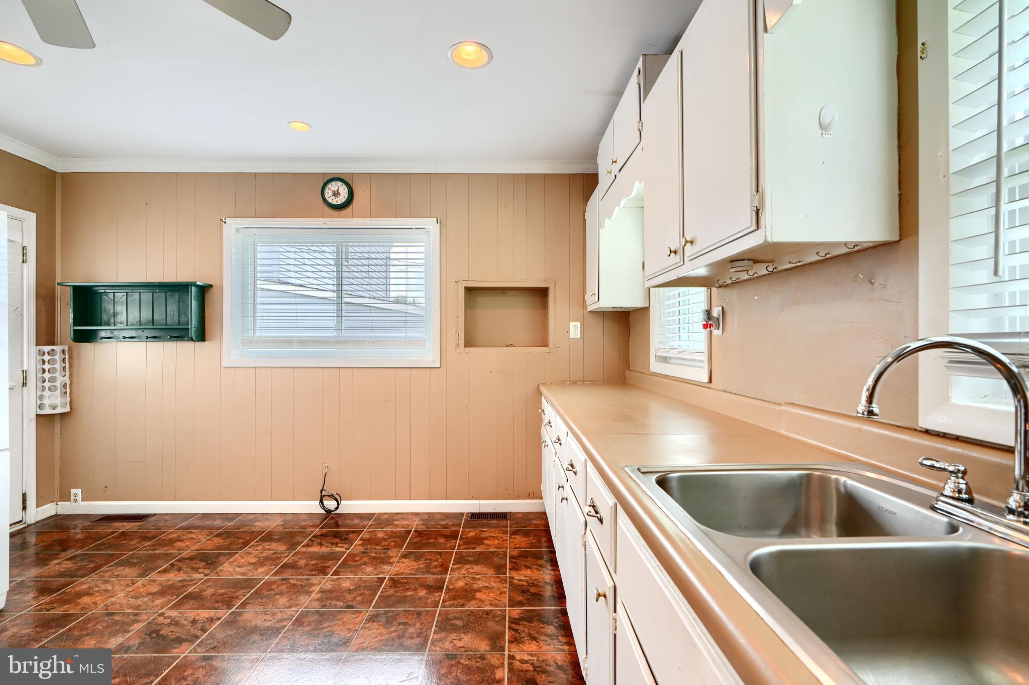235 Trappe Road Baltimore, MD 21222 - Photo 18 of 37 a kitchen with a sink a stove and a microwave