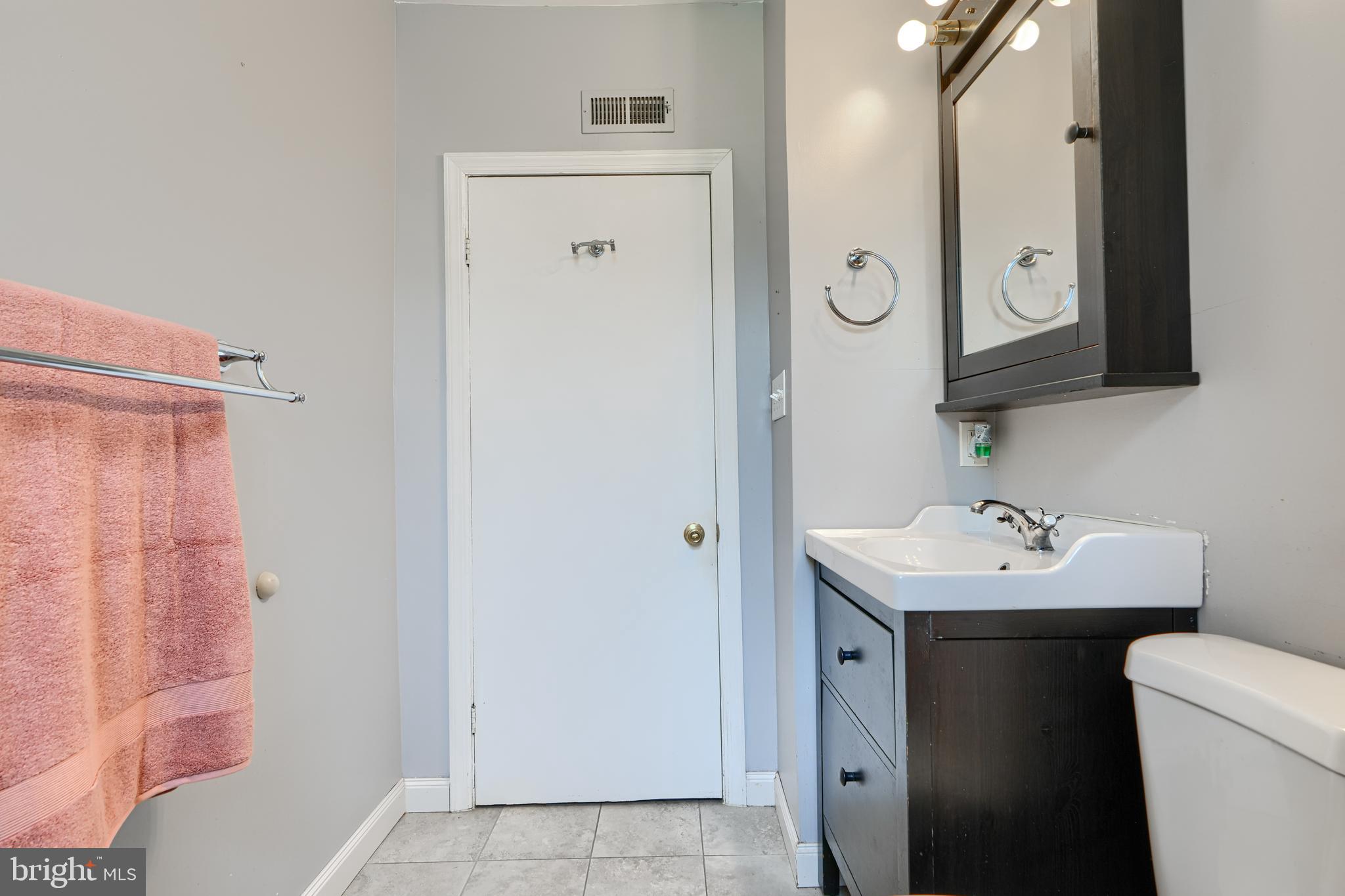 235 Trappe Road Baltimore, MD 21222 - Photo 26 of 37 a bathroom with a toilet a sink and a mirror
