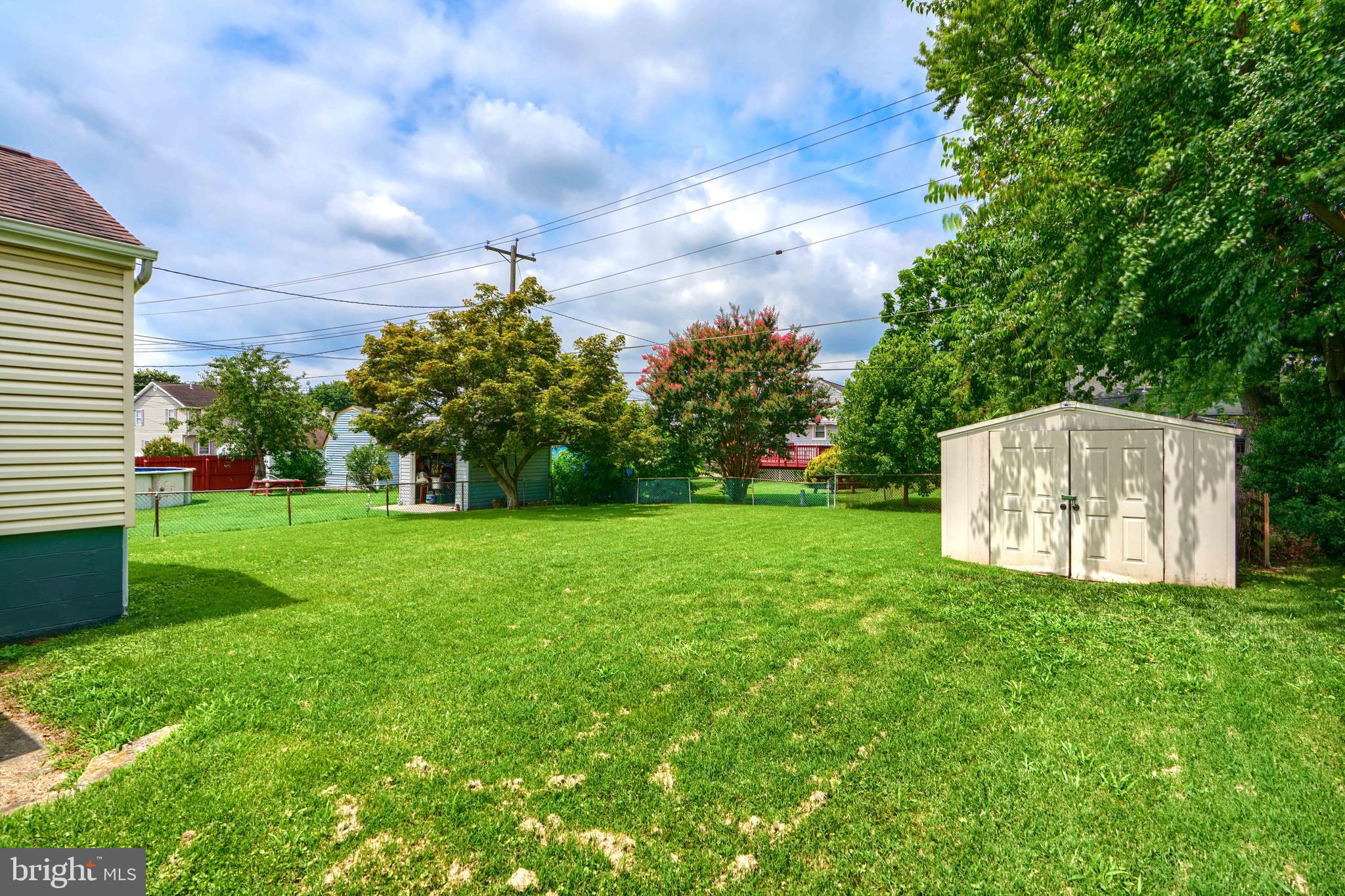 235 Trappe Road Baltimore, MD 21222 - Photo 6 of 37 a view of a tiny house with a big yard and large tree