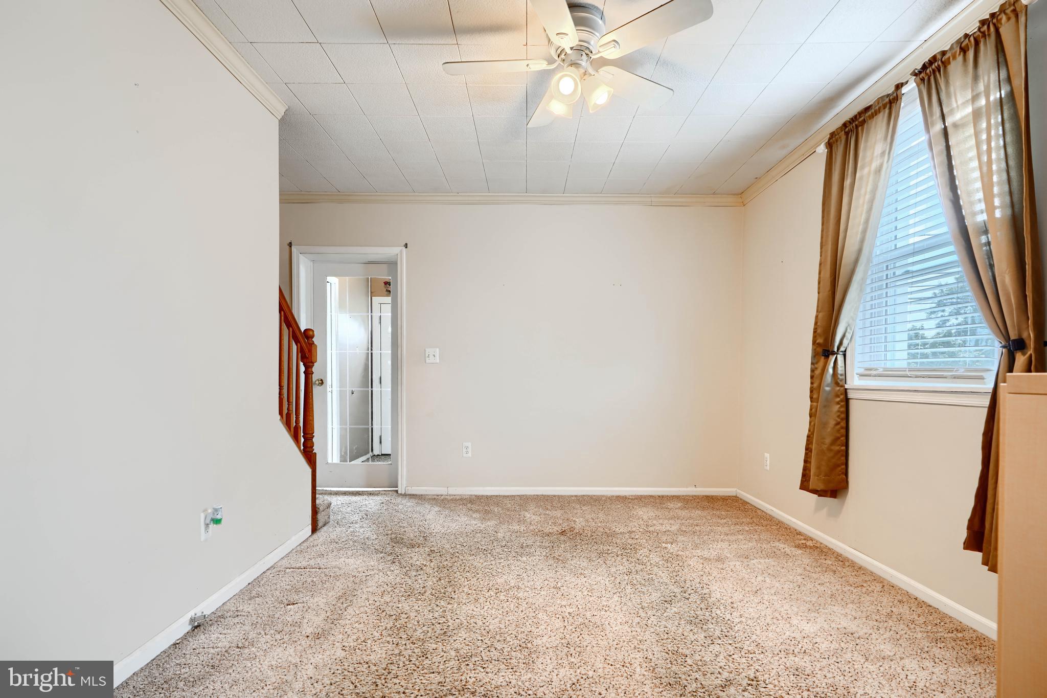 235 Trappe Road Baltimore, MD 21222 - Photo 10 of 37 an empty room with a ceiling fan and window