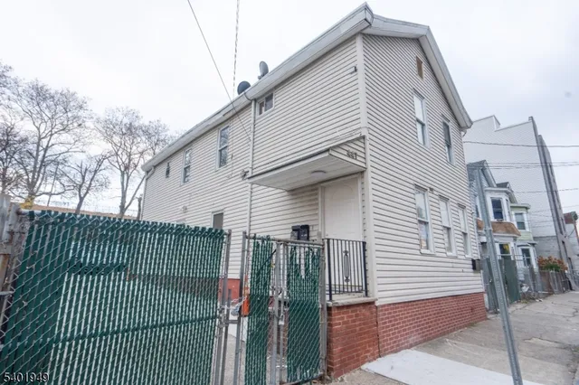 a view of a house with a iron gate