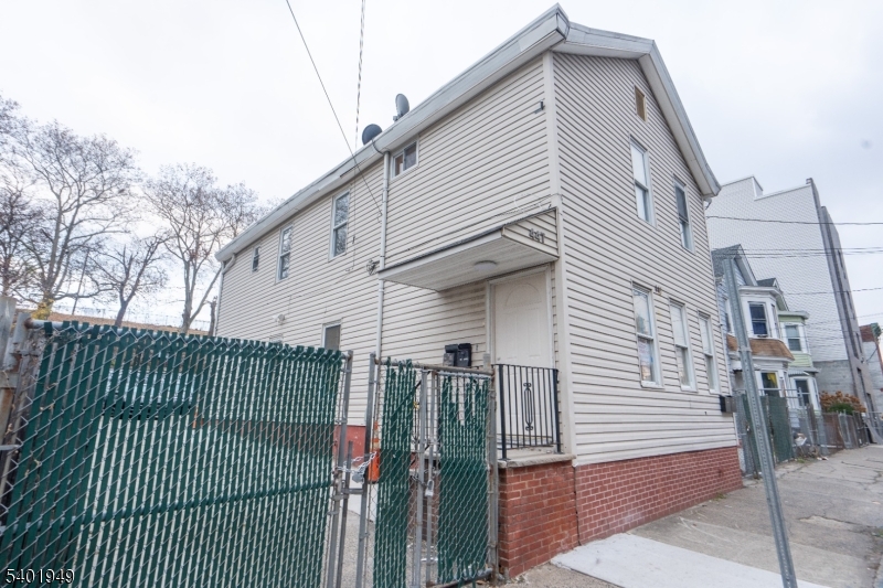 445 Summer Street Paterson, NJ 07501 - Photo 2 of 12 a view of a house with a iron gate