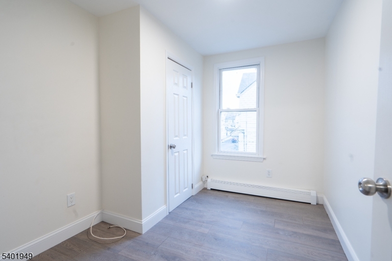 445 Summer Street Paterson, NJ 07501 - Photo 9 of 12 a view of an empty room with closet and a window