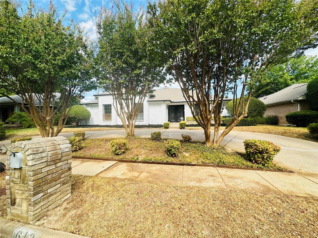 613 Glenview Circle Garland, TX 75040 - Photo 1 of 1 a view of a yard with plants and large trees