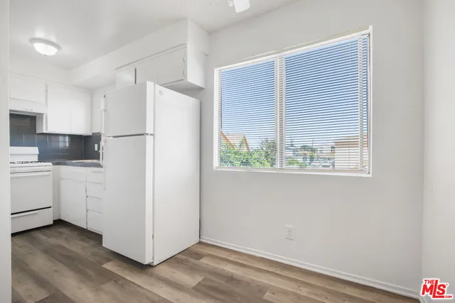 a white refrigerator freezer sitting inside of a kitchen