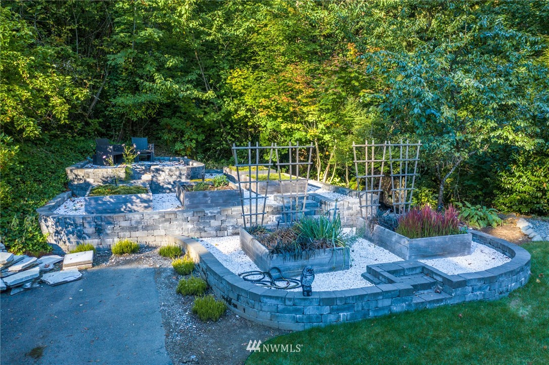 17426 Southeast May Valley Road Renton, WA 98059 - Photo 14 of 19 a view of a swimming pool with a sitting chair and fire pit