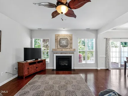 a living room with furniture fireplace and window