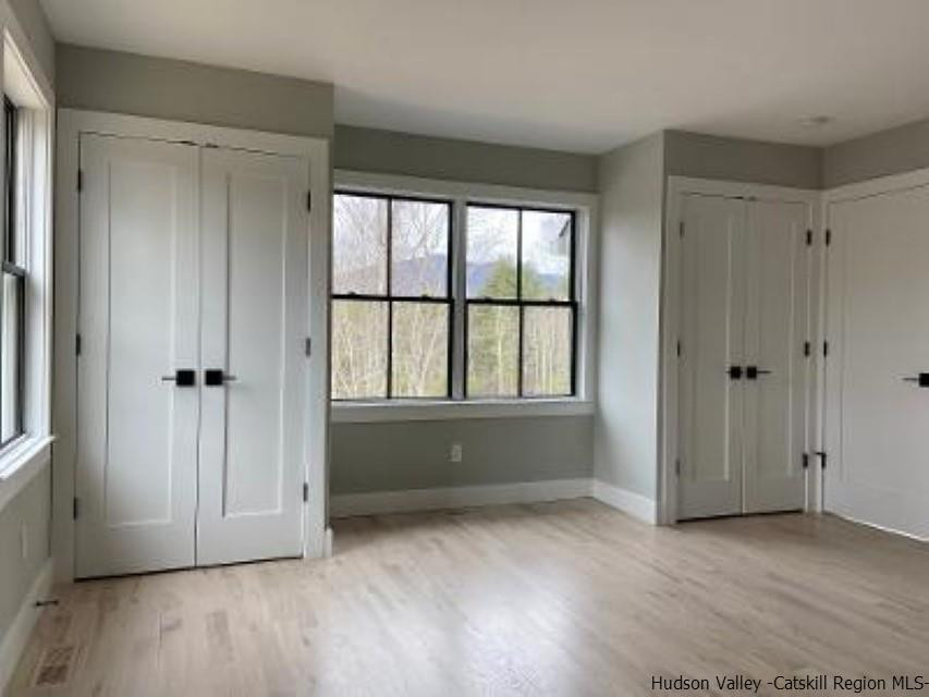194 Lower Sahler Mill Road Olivebridge, NY 12461 - Photo 13 of 16 an empty room with wooden floor and windows