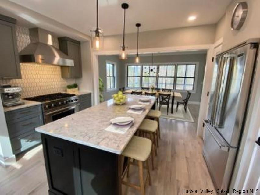 194 Lower Sahler Mill Road Olivebridge, NY 12461 - Photo 5 of 16 a kitchen with stainless steel appliances granite countertop a stove a refrigerator a kitchen island a table and chairs