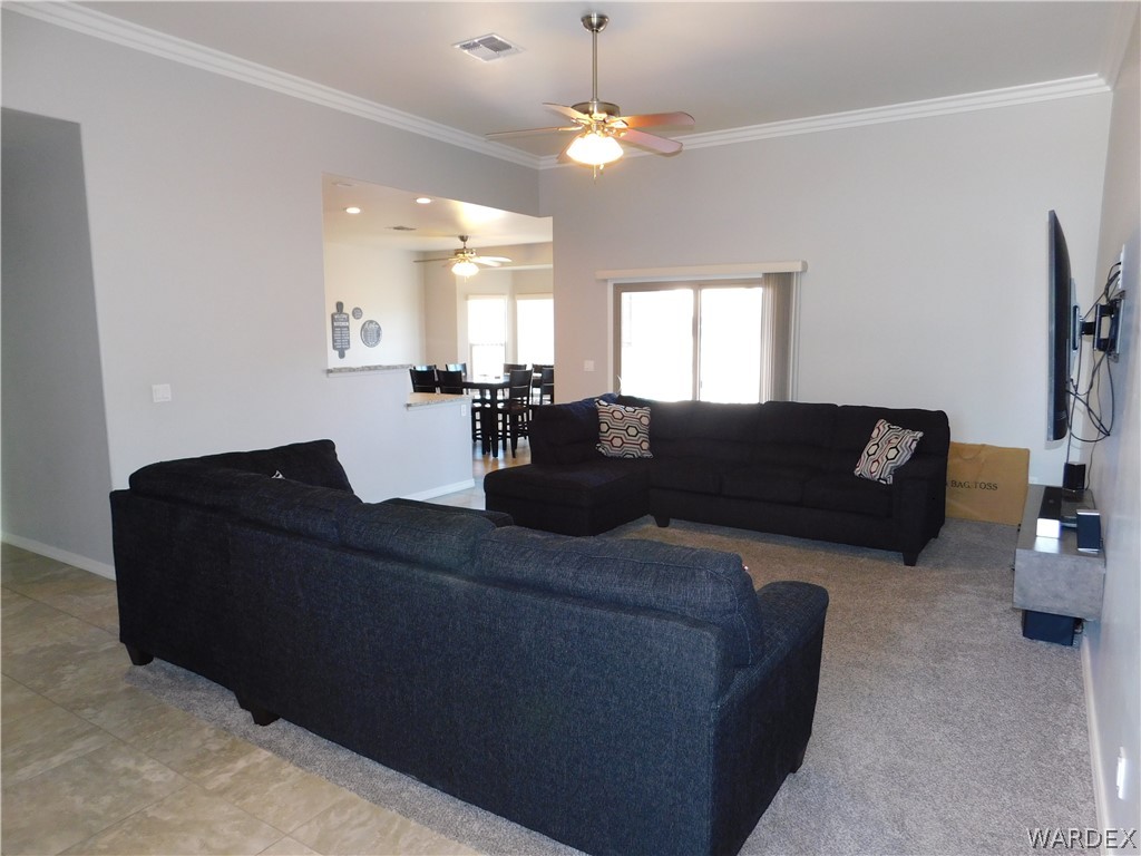 3370 South Ridge Avenue Bullhead City, AZ 86429 - Photo 24 of 56 a living room with furniture and a chandelier